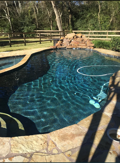 Freeform pool with resurfaced concrete deck