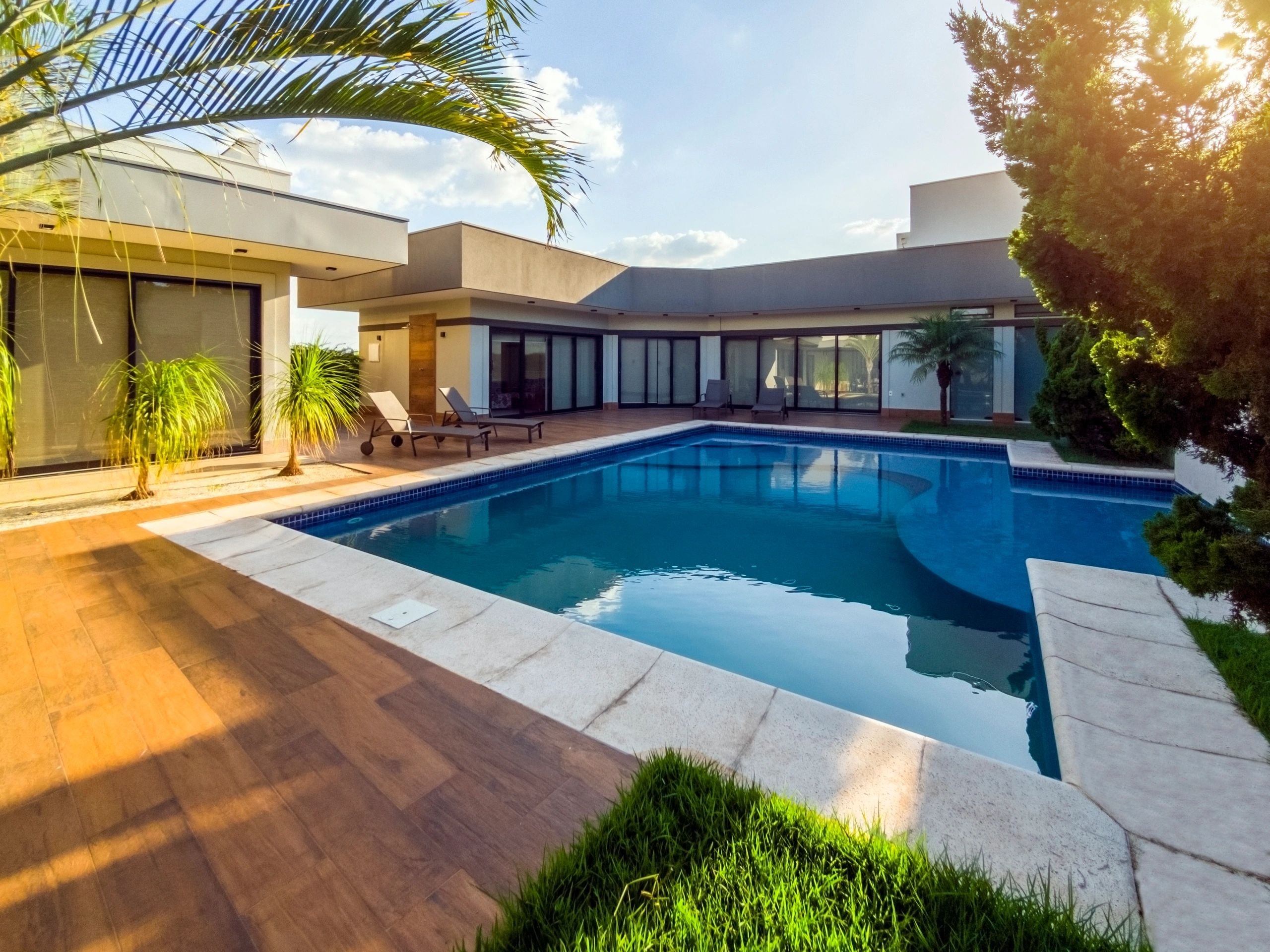 Luxury pool with wood deck and outdoor living area