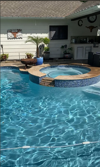 Pool with spa and blue mosaic tile feature