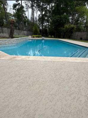 Teal pool with patio and tropical landscaping