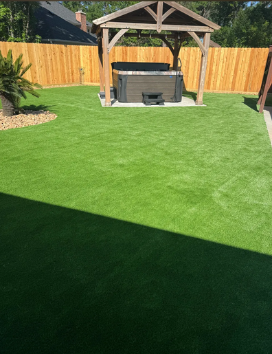 Artificial turf backyard with gazebo and hot tub