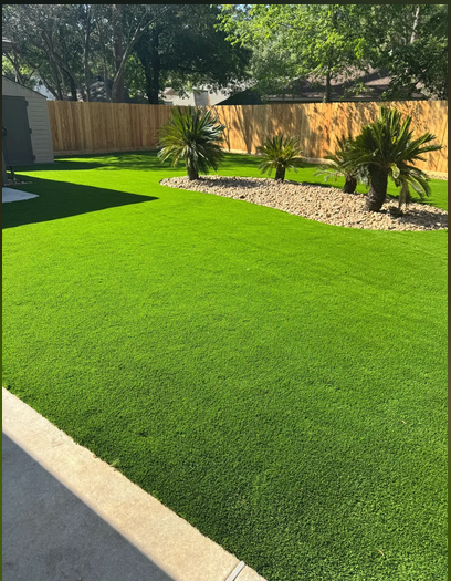 Artificial turf with palm trees and rock landscaping